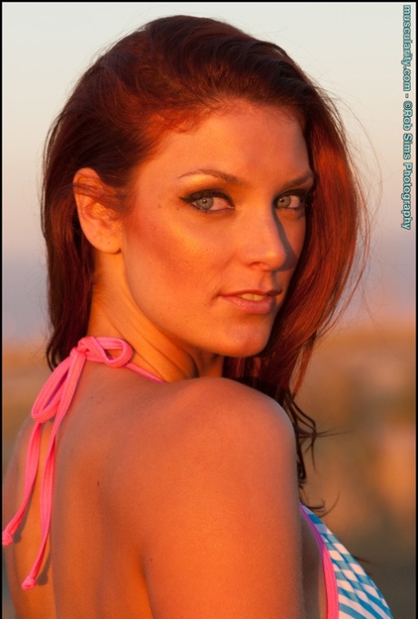 Fit redhead Tierney Flickler changes from a bikini into athletic wear