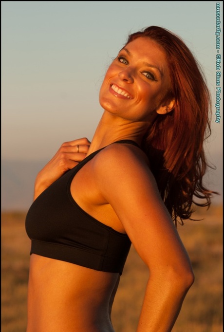 Fit redhead Tierney Flickler changes from a bikini into athletic wear