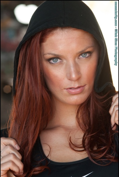 Fit redhead Tierney Flickler changes from a bikini into athletic wear