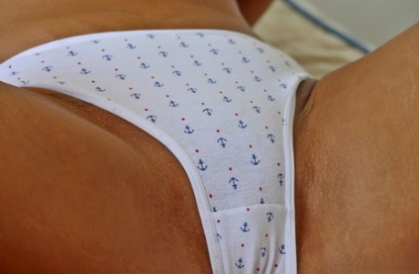 Mature blonde Natalie K shows off her saggy tits & her big booty in panties