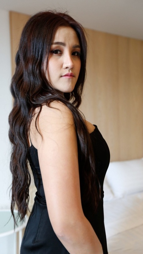 Beautiful Asian girl Zin shows her big tits while undressing for POV sex