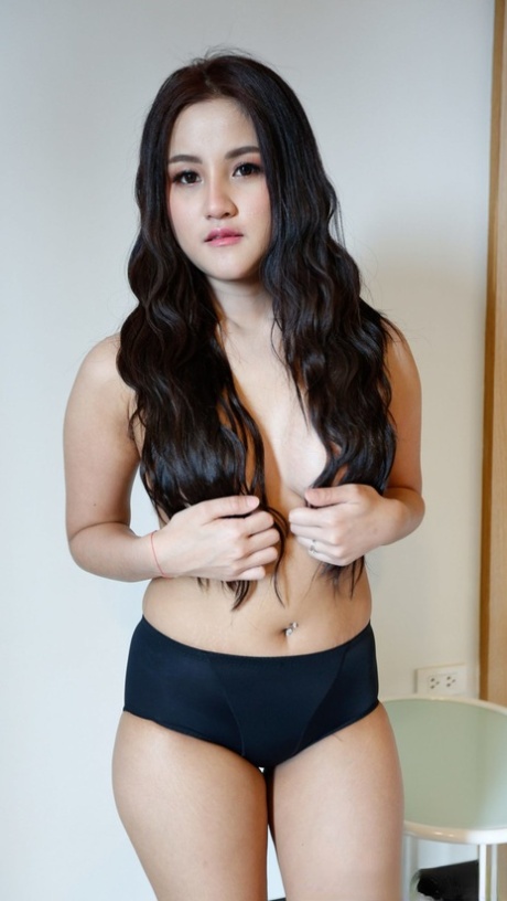 Beautiful Asian girl Zin shows her big tits while undressing for POV sex
